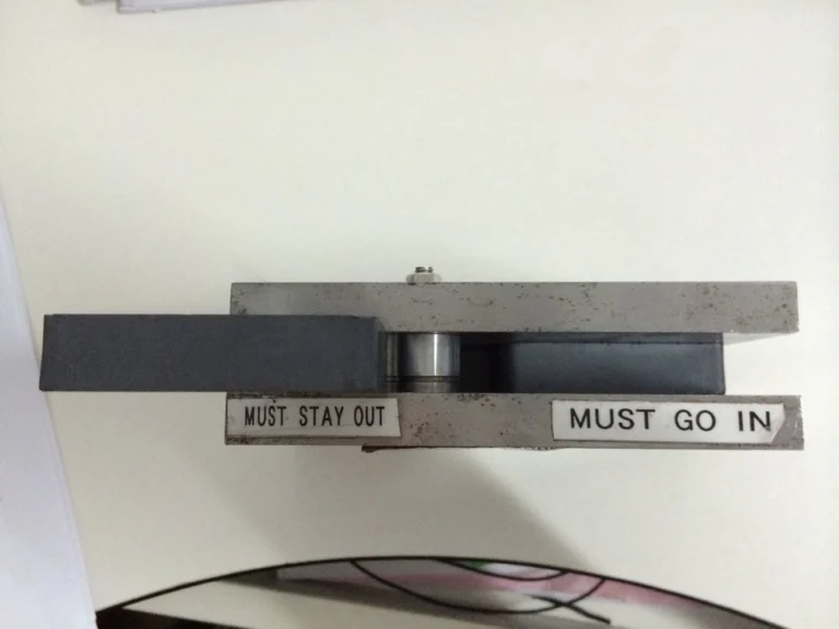 GO/NO-GO gauge with pass and reject limits for a magnet dimension check.